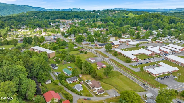 aerial view with a mountain view and a view of trees