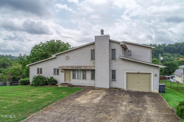 view of front of property with a garage and a front lawn