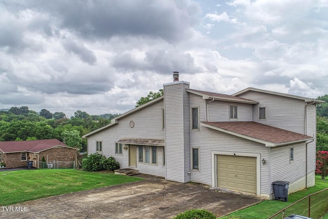 view of front of property with a garage and a front lawn