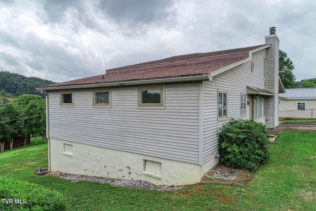 view of home's exterior featuring a lawn