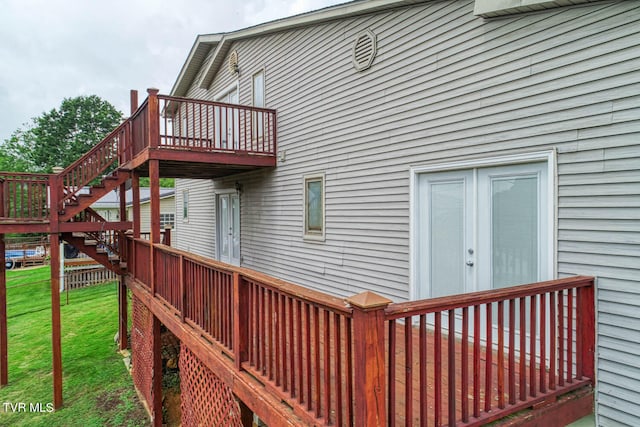 wooden deck featuring a yard