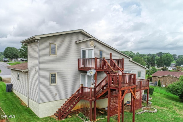 back of property with central AC unit, a yard, and a deck