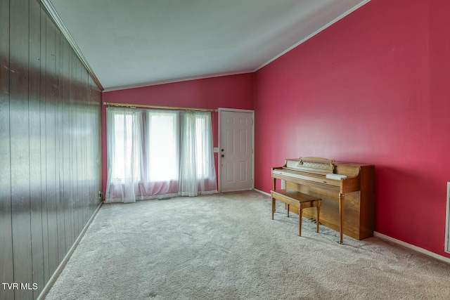 miscellaneous room with carpet floors, crown molding, wooden walls, and lofted ceiling