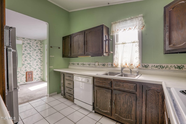 kitchen featuring white dishwasher, dark brown cabinetry, and light tile patterned floors