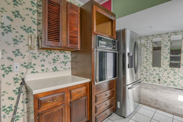 kitchen featuring wall oven, stainless steel fridge with ice dispenser, and light carpet