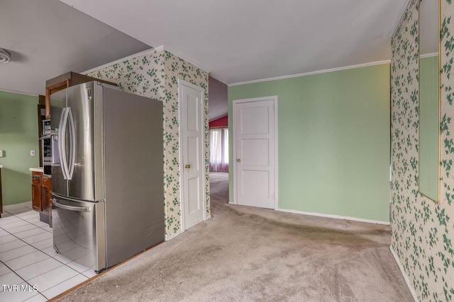 kitchen with ornamental molding, light colored carpet, and stainless steel fridge