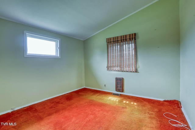 unfurnished room featuring ornamental molding, lofted ceiling, carpet, and heating unit