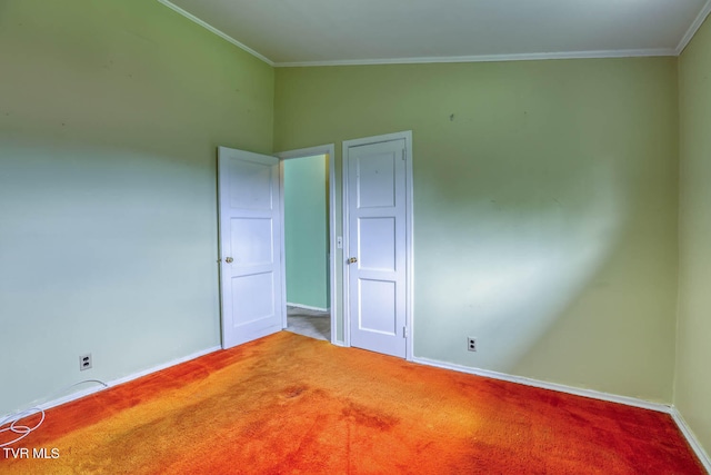 carpeted empty room with lofted ceiling and ornamental molding