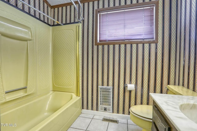 full bathroom with tub / shower combination, tile patterned flooring, heating unit, vanity, and toilet