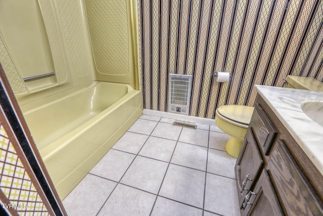 bathroom featuring vanity, toilet, tile patterned flooring, and heating unit