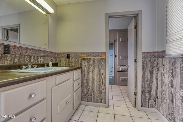 bathroom featuring vanity, tile patterned floors, and tasteful backsplash