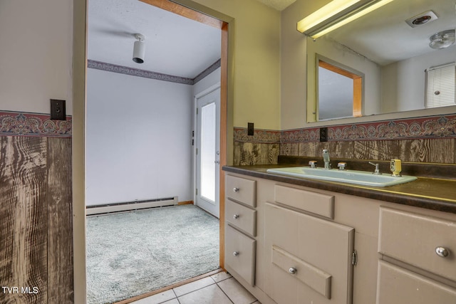 bathroom featuring backsplash, tile patterned floors, a baseboard radiator, and vanity