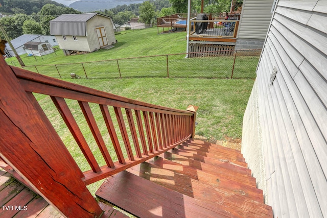 exterior space featuring a trampoline, a yard, and a storage unit