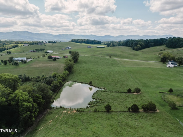 drone / aerial view with a water and mountain view and a rural view