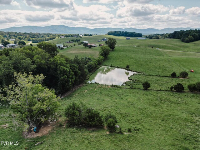 drone / aerial view featuring a water and mountain view and a rural view