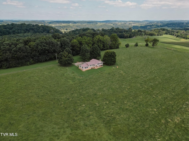 drone / aerial view featuring a rural view and a view of trees