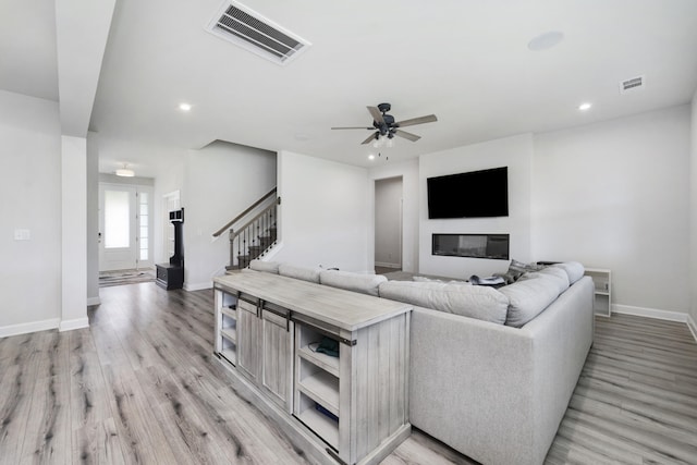 living room with hardwood / wood-style flooring and ceiling fan