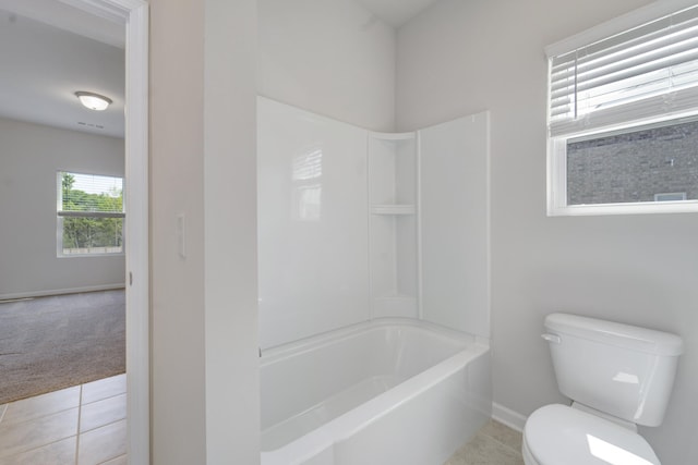 bathroom featuring shower / bathtub combination, tile patterned flooring, and toilet