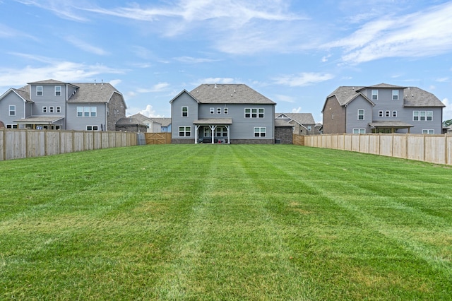 back of property with a lawn