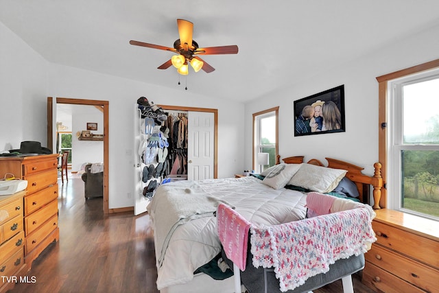 bedroom featuring dark hardwood / wood-style floors, vaulted ceiling, a closet, and ceiling fan