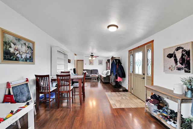 dining area with ceiling fan and dark hardwood / wood-style flooring