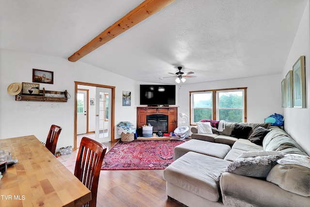 living room featuring vaulted ceiling with beams, ceiling fan, and hardwood / wood-style floors