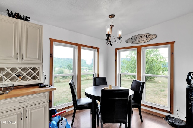 dining space with a notable chandelier and light hardwood / wood-style floors