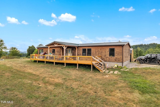 back of house featuring a deck and a lawn