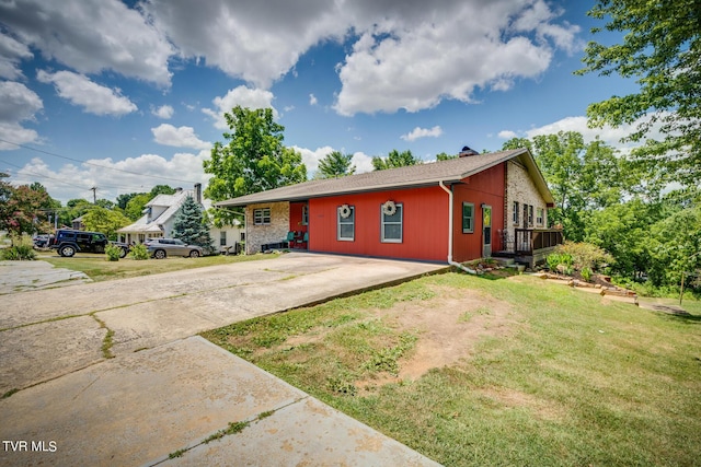 single story home with a front yard and a deck