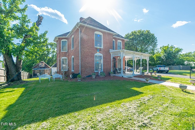 exterior space with fence, a front lawn, and brick siding