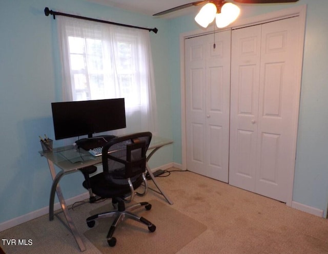 carpeted office space with ceiling fan