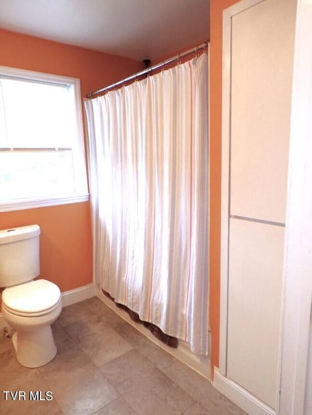 bathroom featuring tile patterned floors and toilet