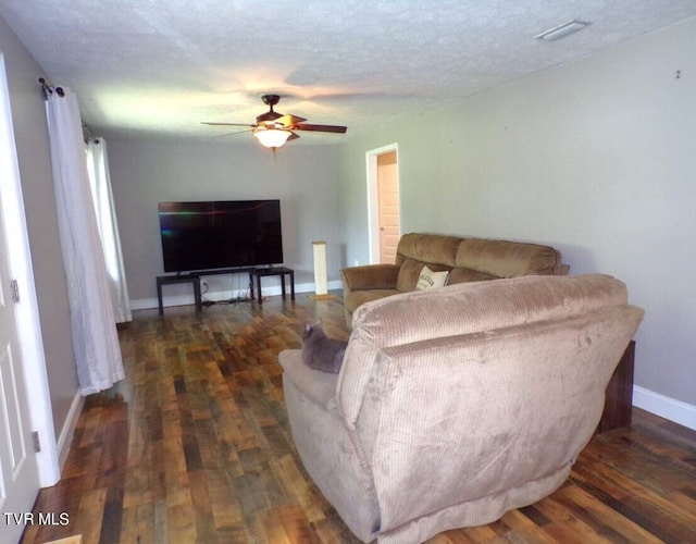 living room with ceiling fan, a textured ceiling, and hardwood / wood-style flooring