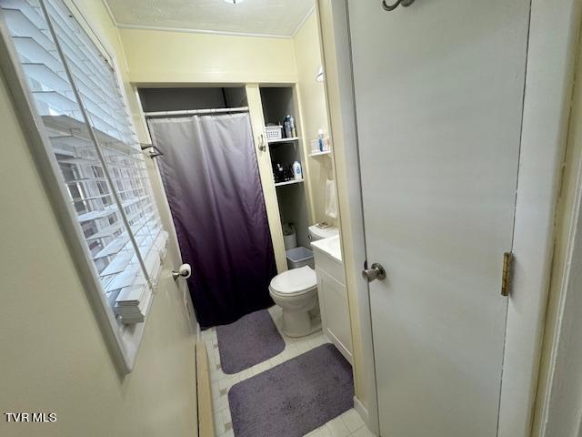 bathroom with vanity, tile patterned floors, and toilet