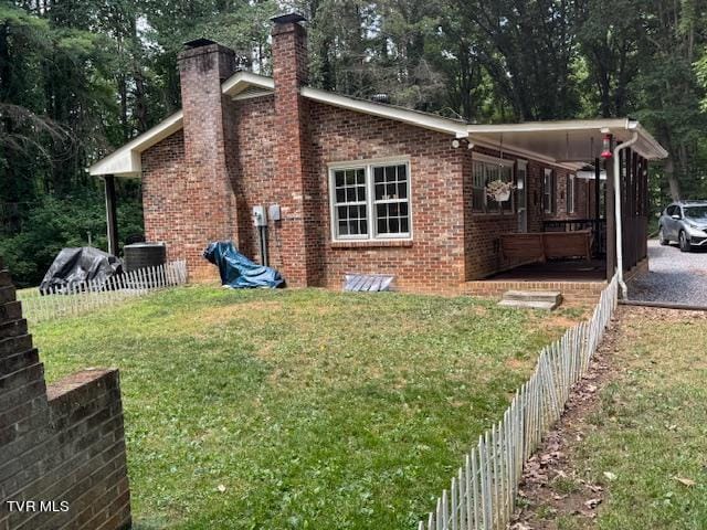 rear view of property featuring a yard