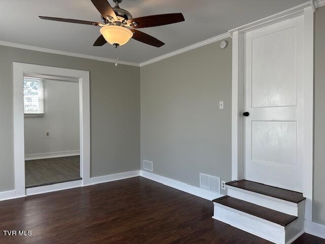 unfurnished bedroom featuring crown molding, dark hardwood / wood-style flooring, and ceiling fan