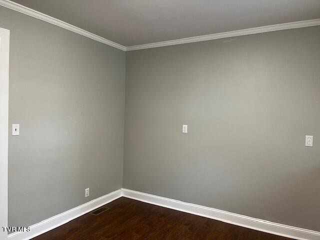 spare room featuring wood-type flooring and ornamental molding