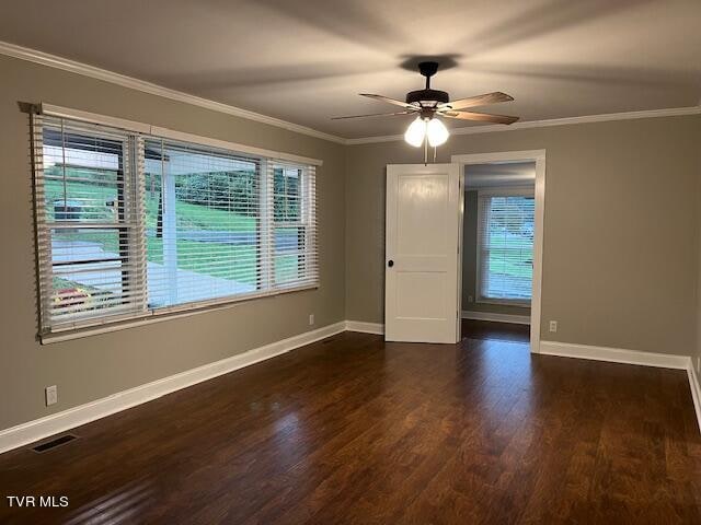 empty room featuring ornamental molding, ceiling fan, and dark hardwood / wood-style flooring