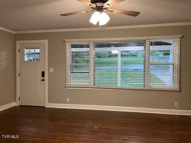 foyer with a ceiling fan, baseboards, dark wood-style floors, and ornamental molding