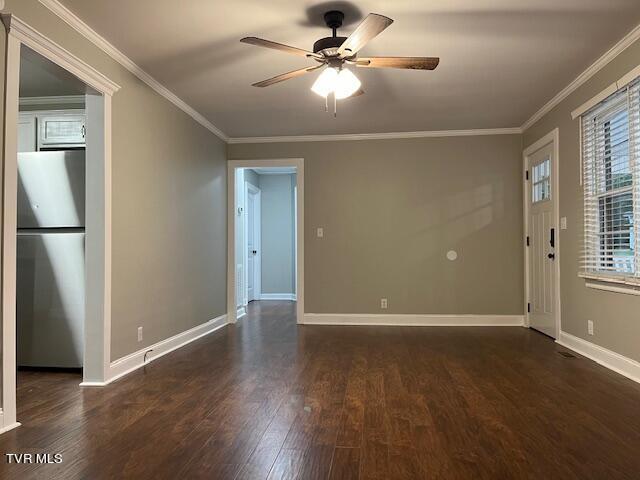 unfurnished room with crown molding, a ceiling fan, baseboards, and dark wood finished floors