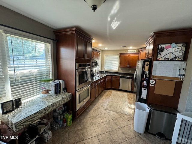 kitchen with appliances with stainless steel finishes and light tile patterned floors