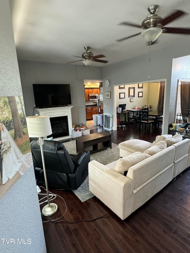 living room with a wealth of natural light, ceiling fan, and wood-type flooring