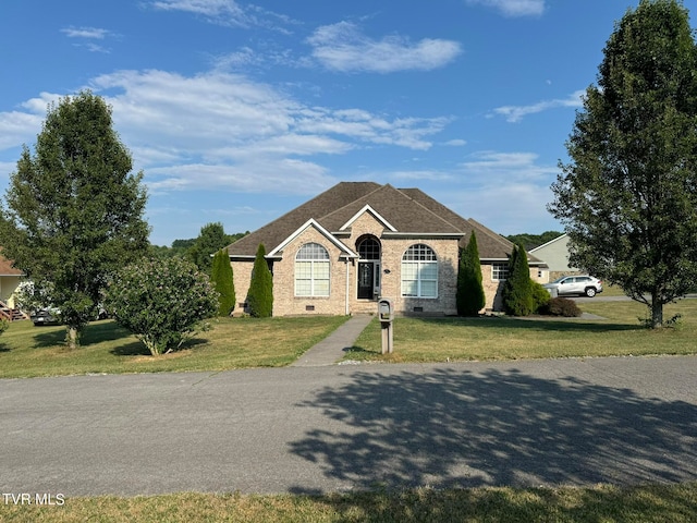 ranch-style home with a front lawn