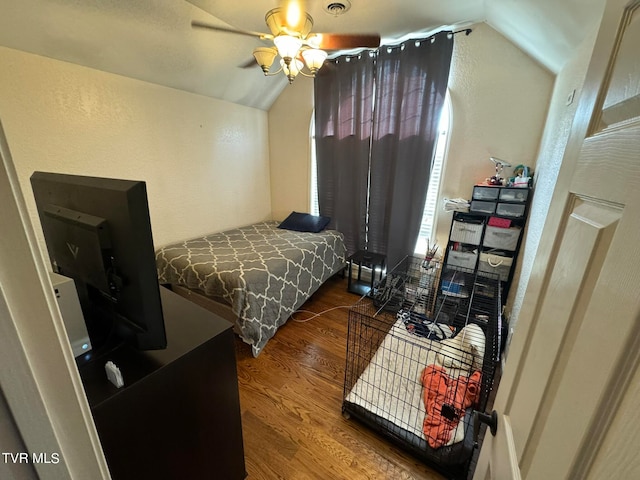 bedroom with hardwood / wood-style flooring, vaulted ceiling, and ceiling fan