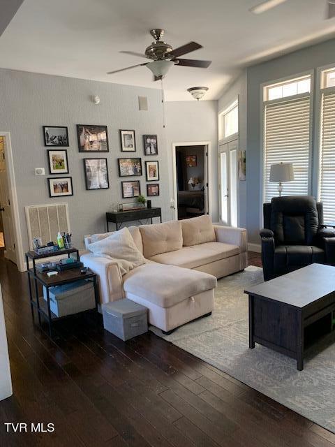 living room featuring hardwood / wood-style floors and ceiling fan