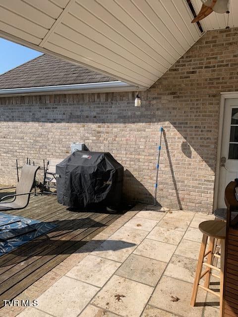 view of patio / terrace with ceiling fan and a grill