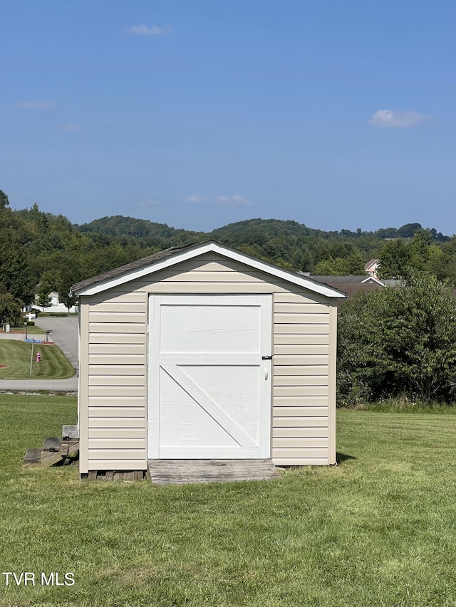 view of outdoor structure with a lawn