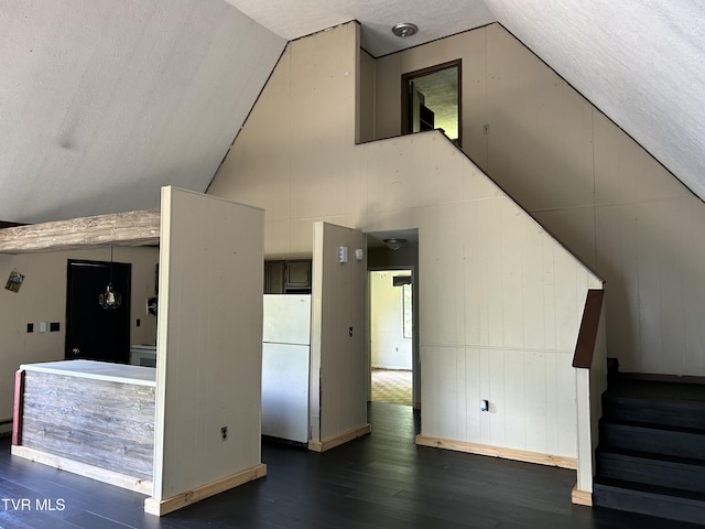 additional living space with dark wood-type flooring and vaulted ceiling