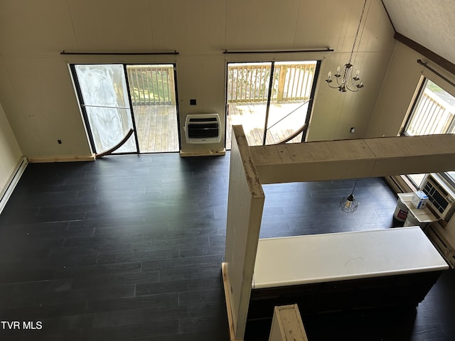 interior space with heating unit and dark hardwood / wood-style flooring