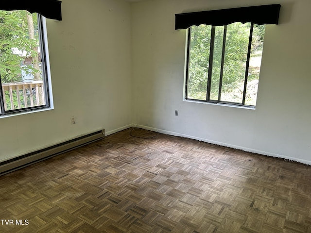 unfurnished room featuring a baseboard radiator and dark parquet floors